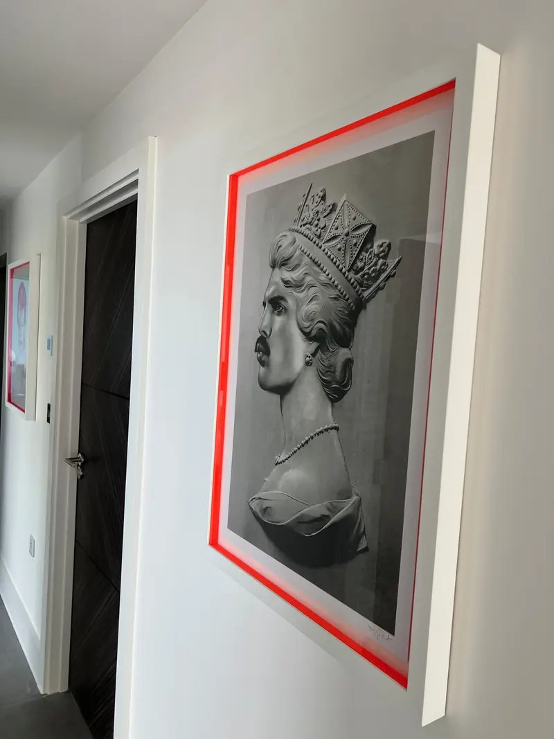 Framed black-and-white sculpture print in the hallway