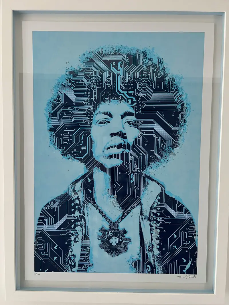Framed blue portrait print on a white wall at Sunkeeper