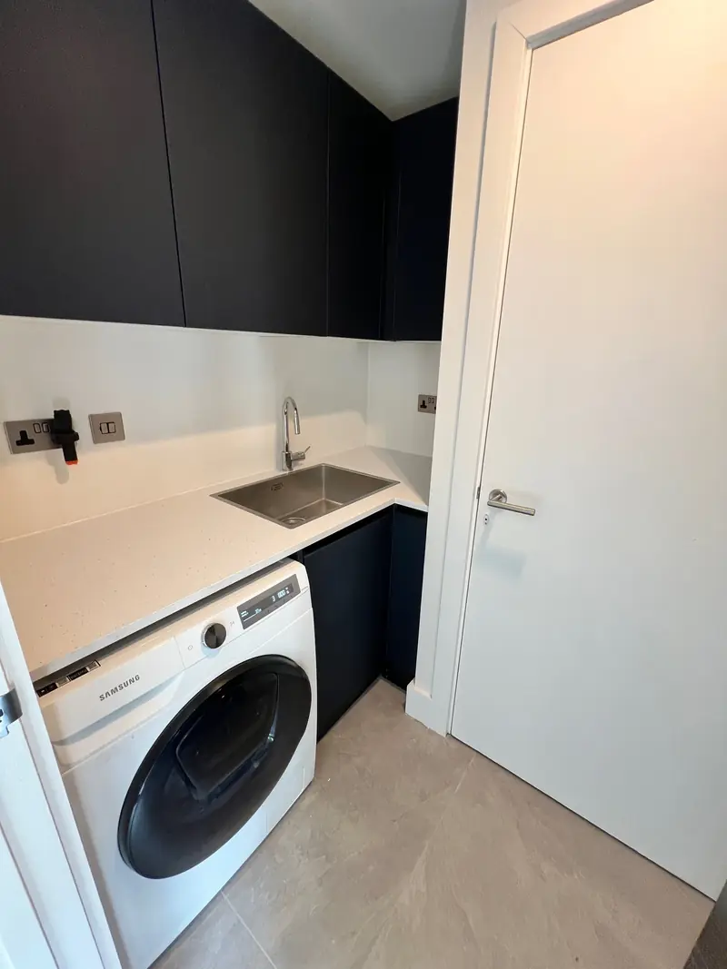 Utility room with washing machine and sink